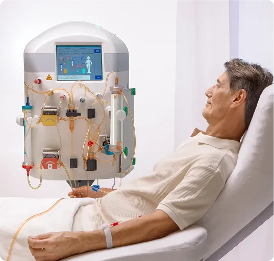 Patient sitting in bed in a hospital connected to a machine for regenerative treatment